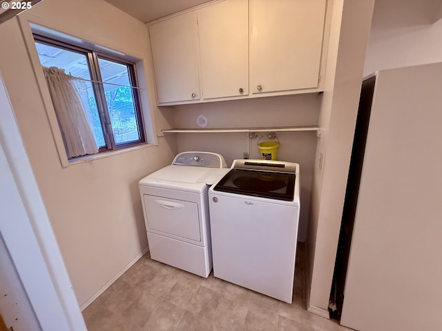 laundry room with cabinets and washer and dryer