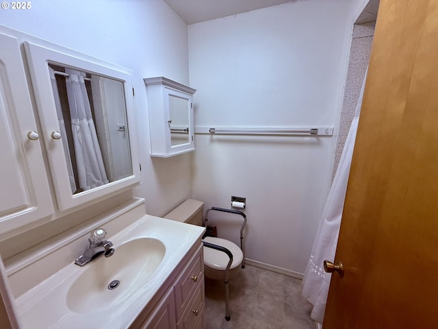 bathroom featuring toilet, vanity, and tile patterned flooring