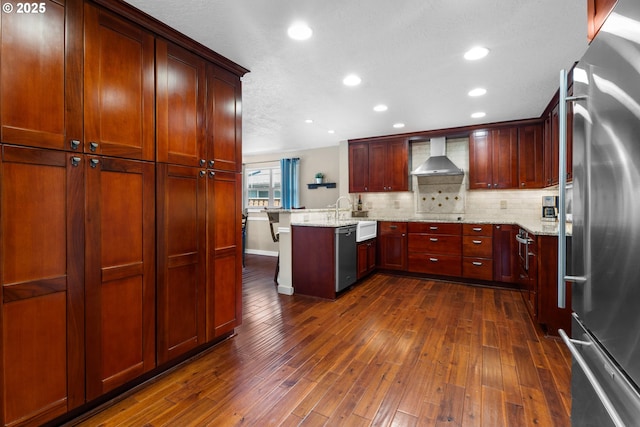 229 N 6th St, Carlton, OR 97111 - kitchen featuring stainless steel appliances, a peninsula, wall chimney range hood, tasteful backsplash, and dark wood finished floors