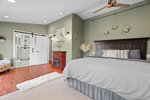 229 N 6th St, Carlton, OR 97111 - bedroom featuring a barn door, wood finished floors, ensuite bathroom, lofted ceiling, and recessed lighting