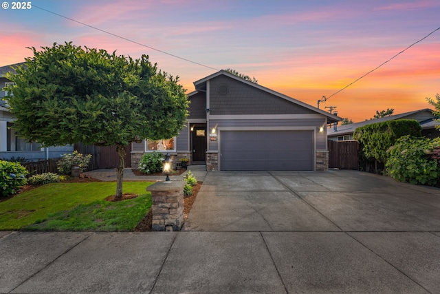 229 N 6th St, Carlton, OR 97111 - view of front of home featuring a garage, stone siding, and concrete driveway