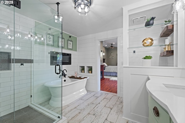 229 N 6th St, Carlton, OR 97111 - full bathroom with connected bathroom, a freestanding tub, wood finished floors, a stall shower, and vanity