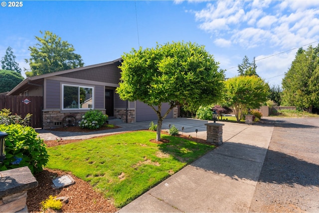 229 N 6th St, Carlton, OR 97111 - obstructed view of property featuring stone siding, driveway, and an attached garage