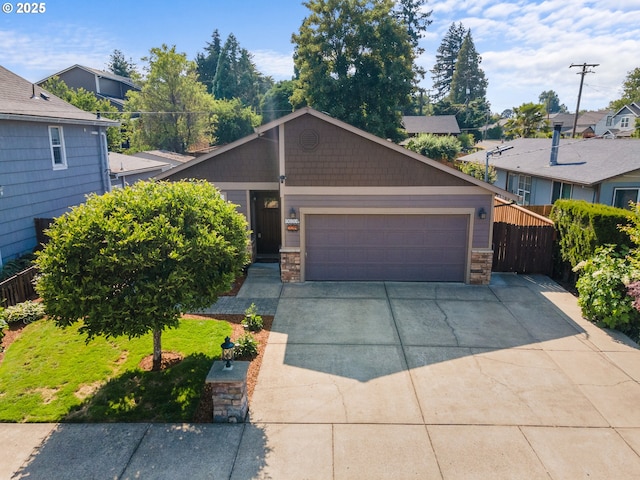 229 N 6th St, Carlton, OR 97111 - view of front of property featuring stone siding, an attached garage, concrete driveway, and a residential view
