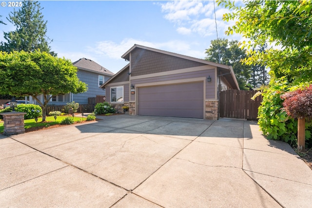 229 N 6th St, Carlton, OR 97111 - view of front of home featuring driveway, a garage, and stone siding