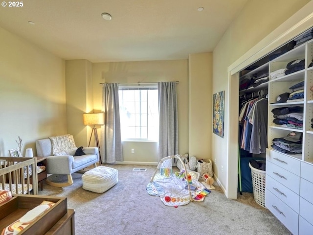 carpeted bedroom with a closet and visible vents
