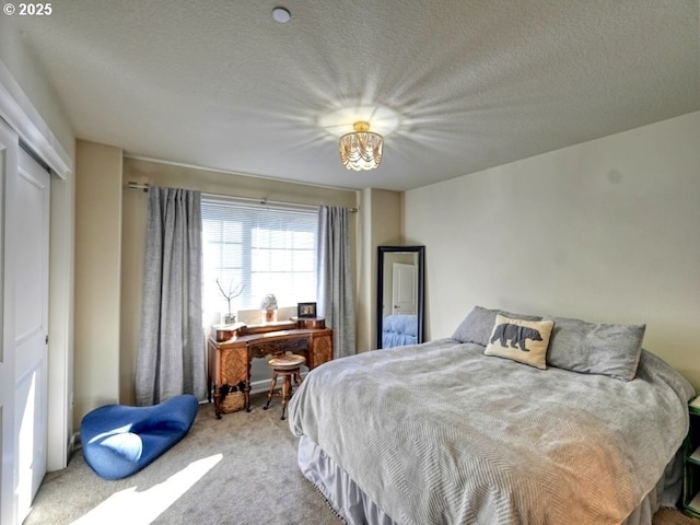 bedroom featuring a textured ceiling, a closet, and carpet floors