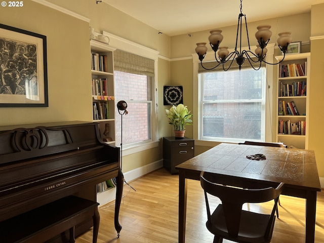 2127 NW Irving St # 202, Portland, OR 97210 - dining space featuring a chandelier and light wood finished floors