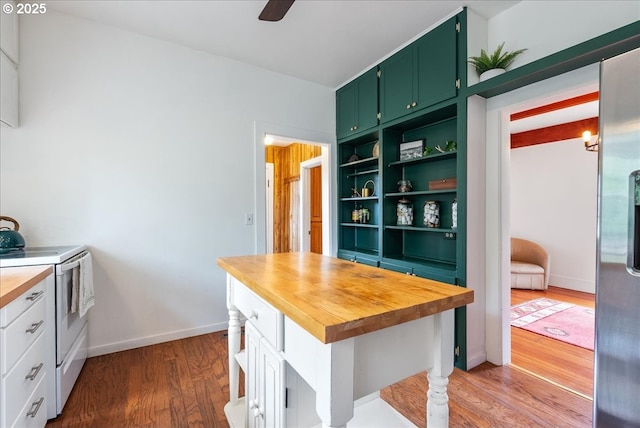 kitchen featuring white range with electric stovetop, green cabinetry, dark wood-type flooring, open shelves, and wooden counters