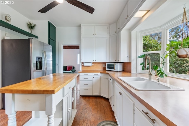 kitchen featuring butcher block counters, a healthy amount of sunlight, white appliances, and open shelves