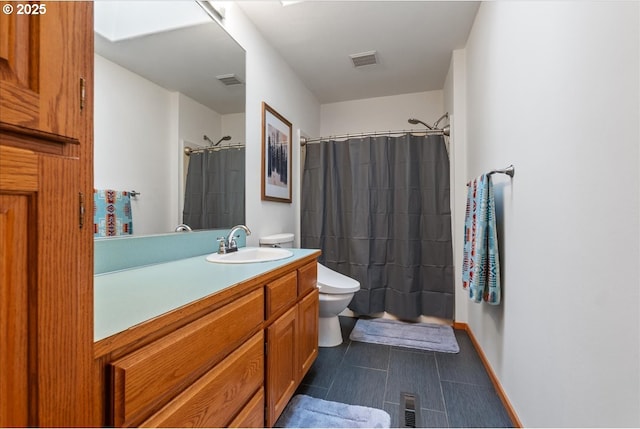 full bathroom with toilet, baseboards, visible vents, and vanity