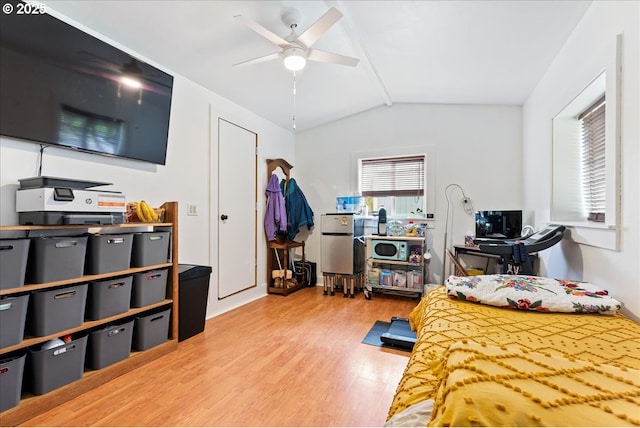 bedroom featuring a ceiling fan, lofted ceiling, and wood finished floors