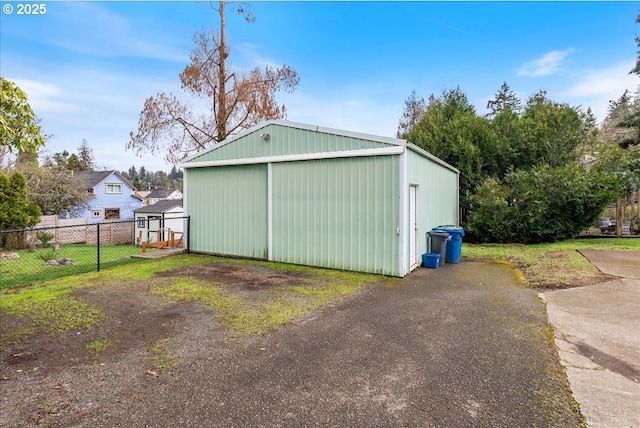 view of pole building with fence