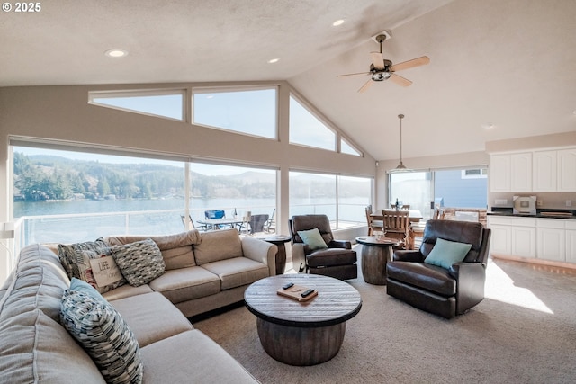 1508 NE Lake Dr, Lincoln City, OR 97367 - carpeted living room featuring high vaulted ceiling, ceiling fan, and a water view