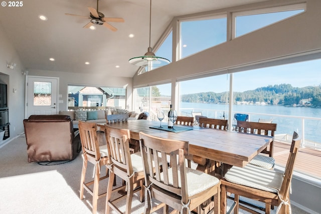1508 NE Lake Dr, Lincoln City, OR 97367 - dining area featuring ceiling fan, carpet flooring, high vaulted ceiling, and a water and mountain view