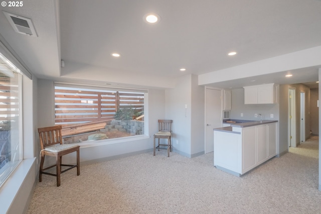 1508 NE Lake Dr, Lincoln City, OR 97367 - kitchen featuring white cabinetry and light colored carpet