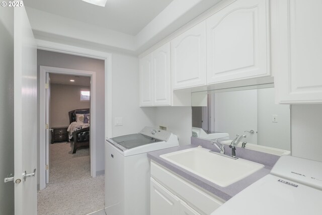 1508 NE Lake Dr, Lincoln City, OR 97367 - washroom with light carpet, sink, cabinets, and independent washer and dryer