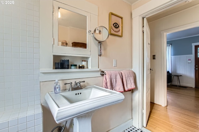 bathroom featuring wood-type flooring and crown molding