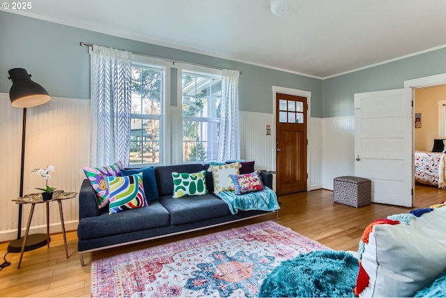 living room with ornamental molding and wood-type flooring