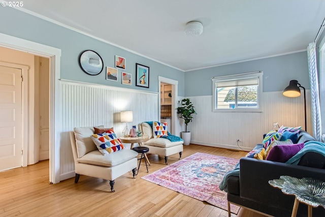 living room with crown molding and hardwood / wood-style floors