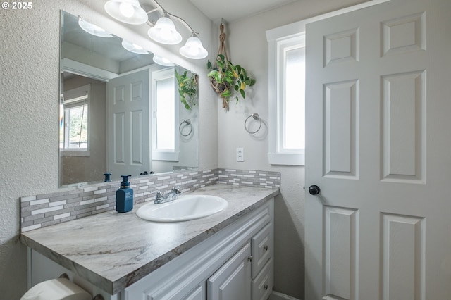 2261 Fulton Pl SE, Albany, OR 97322 - bathroom with vanity, tasteful backsplash, and a textured wall