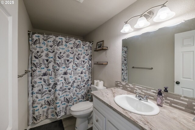 2261 Fulton Pl SE, Albany, OR 97322 - bathroom with vanity, toilet, tasteful backsplash, a shower with curtain, and a textured wall