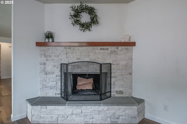 2261 Fulton Pl SE, Albany, OR 97322 - detailed view of wood finished floors, baseboards, and a stone fireplace