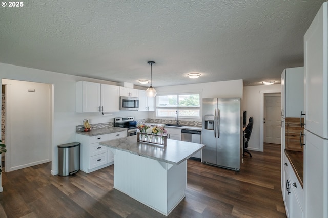 2261 Fulton Pl SE, Albany, OR 97322 - kitchen featuring appliances with stainless steel finishes, a sink, dark wood-type flooring, white cabinetry, and a textured ceiling