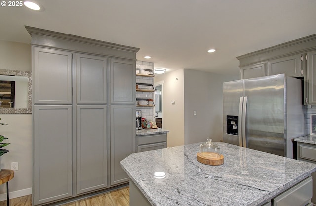 7716 NE 136th Ave, Vancouver, WA 98682 - kitchen with gray cabinets, stainless steel fridge, light wood-type flooring, open shelves, and recessed lighting