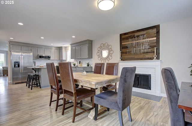 7716 NE 136th Ave, Vancouver, WA 98682 - dining area with light wood finished floors, a fireplace, and recessed lighting