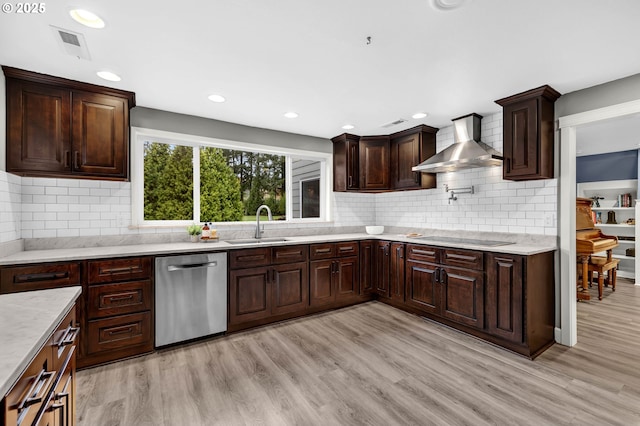 kitchen featuring wall chimney exhaust hood, sink, stainless steel dishwasher, black electric stovetop, and light hardwood / wood-style floors