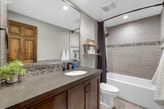 full bathroom with vanity, backsplash, toilet, and shower / bath combo with shower curtain