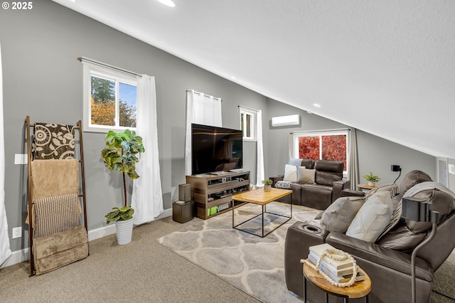 living room featuring lofted ceiling, a wall mounted AC, baseboards, and light colored carpet