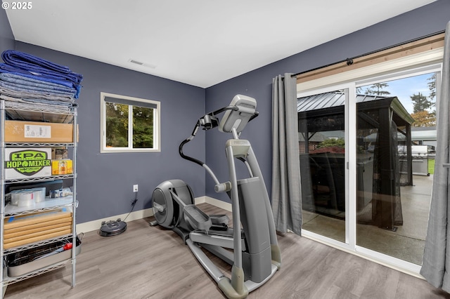 workout area with wood-type flooring