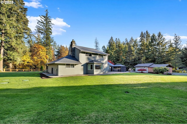 back of property with a chimney and a yard