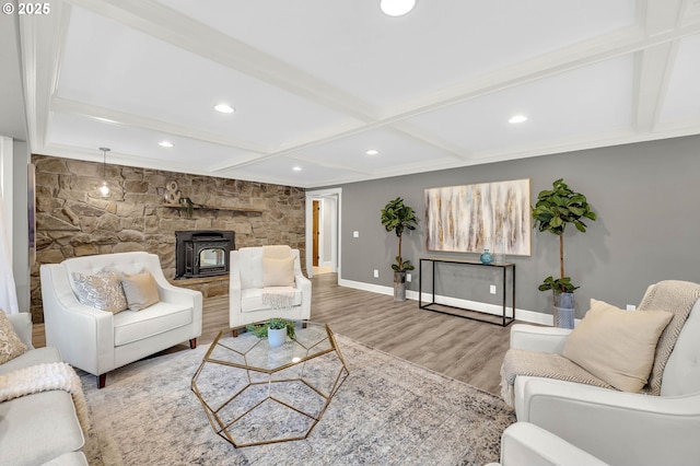 living room with coffered ceiling, beam ceiling, wood-type flooring, and a wood stove