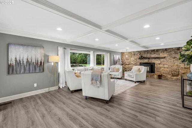 unfurnished living room featuring coffered ceiling, hardwood / wood-style flooring, ornamental molding, beamed ceiling, and a fireplace