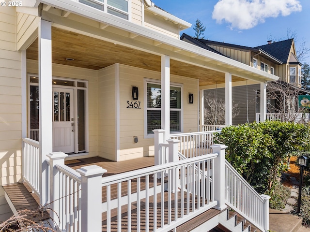 doorway to property featuring covered porch and board and batten siding