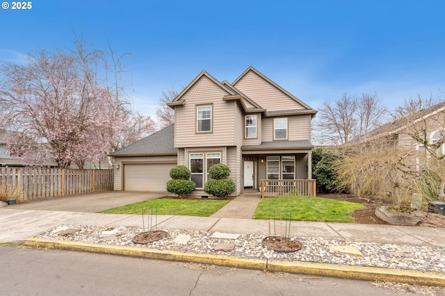 view of front of home with fence, driveway, covered porch, a front lawn, and a garage