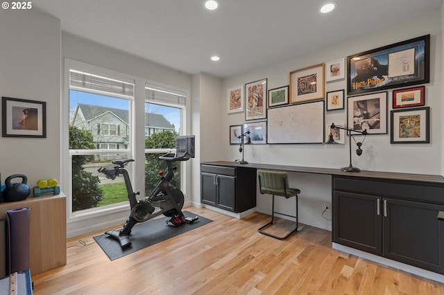 exercise area featuring recessed lighting, light wood-type flooring, and baseboards