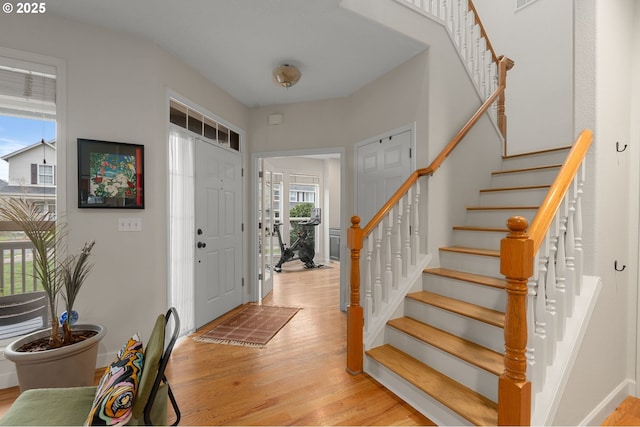 entrance foyer with stairway and light wood-style flooring