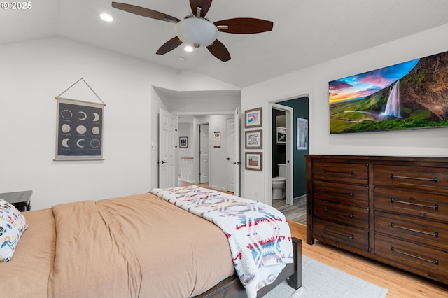 bedroom featuring a ceiling fan, recessed lighting, vaulted ceiling, light wood-style floors, and ensuite bathroom