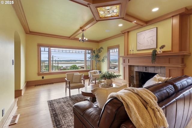 7506 SE Evergreen Hwy, Vancouver, WA 98664 - living area with arched walkways, a tiled fireplace, light wood-type flooring, ornamental molding, and a chandelier