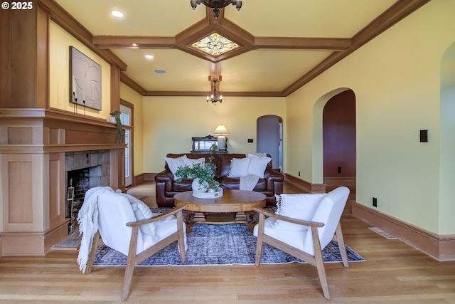 7506 SE Evergreen Hwy, Vancouver, WA 98664 - living area featuring arched walkways, a tile fireplace, light wood finished floors, coffered ceiling, and crown molding