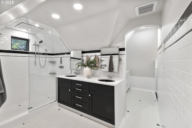 7506 SE Evergreen Hwy, Vancouver, WA 98664 - full bathroom featuring tile patterned floors, walk in shower, double vanity, tile walls, and lofted ceiling