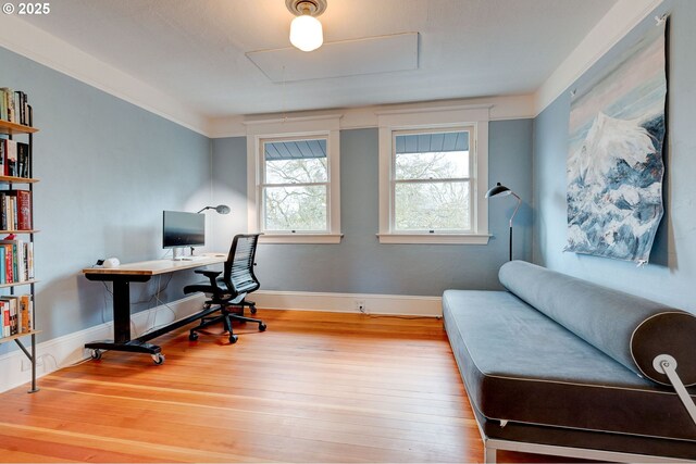 office space featuring attic access, wood finished floors, and baseboards