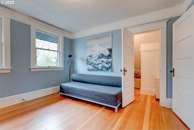 living area with baseboards and light wood finished floors