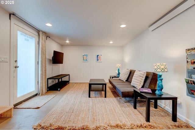 living room featuring recessed lighting and baseboards