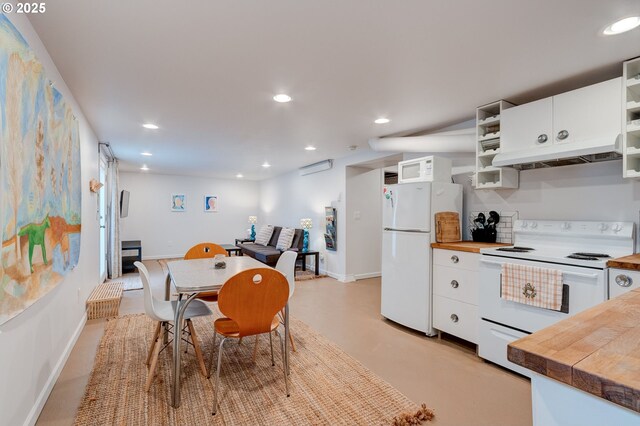 dining space with recessed lighting, baseboards, and concrete floors