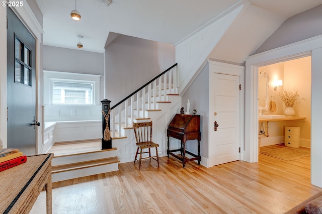 entrance foyer with stairs and light wood-style floors